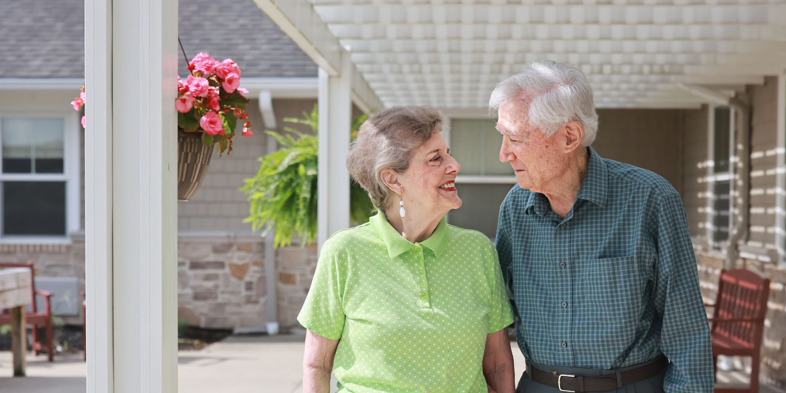Resident couple outdoors at Hudson Grande Senior Living, [locationaddress]